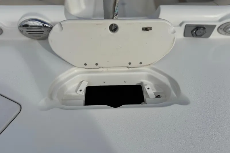 Slide: The Image of 2013 NauticStar 203 SC boat compartment with open hatch and visible interior. - 9