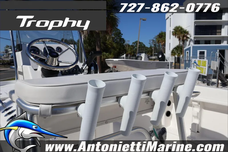 Slide: The Image of Trophy T18 Bay 2026 boat with rod holders, steering wheel, and marine dealership details. - 32
