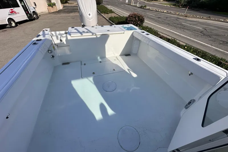 Slide: The Image of 2026 Parker 227 Explorer boat deck, spacious and clean, parked outdoors. - 12