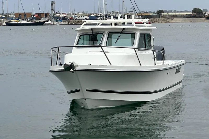 Slide: The Image of Interior of 2026 Parker 227 Explorer boat with white seating and steering wheel. - 4