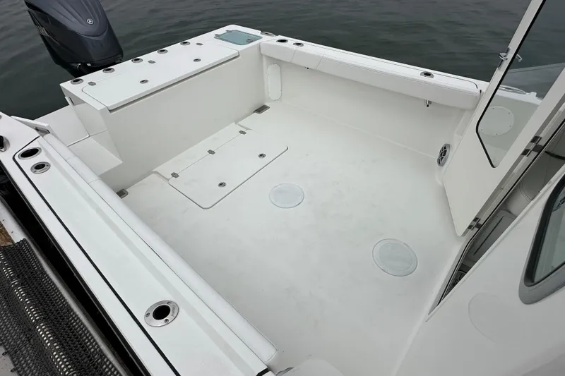 Slide: The Image of Captain's chair on 2026 Parker 227 Explorer boat, featuring sleek white upholstery. - 6