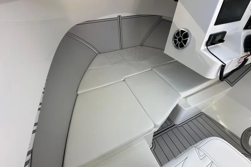 Slide: The Image of Interior of 2026 Parker 227 Explorer boat with cushioned seating and control panel. - 9