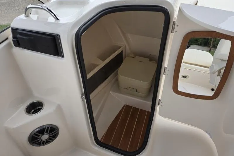 Slide: The Image of Interior of 2026 Grady-White Freedom 215 boat with compact cabin and toilet. - 14