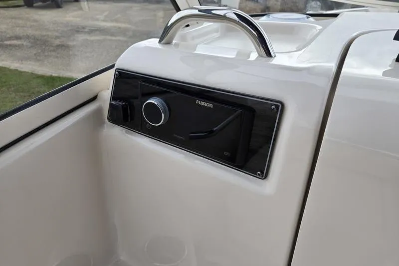 Slide: The Image of 2026 Grady-White Freedom 215 boat dashboard with Fusion audio system. - 16