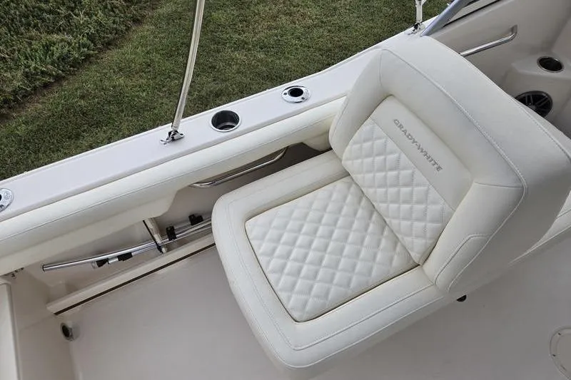 Slide: The Image of 2026 Grady-White Freedom 215 boat seat with quilted design and cup holders. - 17