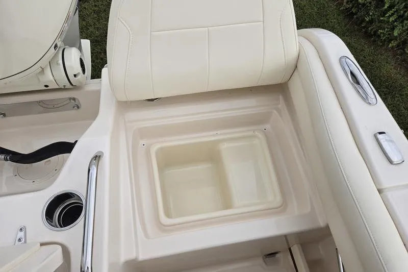 Slide: The Image of 2026 Grady-White Freedom 215 boat interior with beige seating and storage compartment. - 21