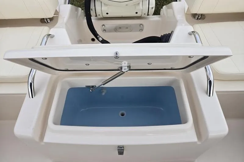 Slide: The Image of Open storage compartment on 2026 Grady-White Freedom 215 boat, featuring a blue interior. - 3