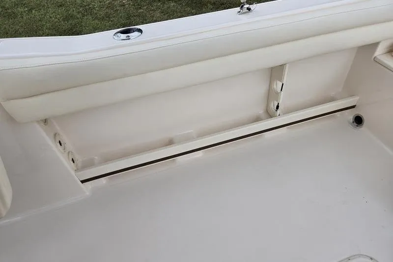 Slide: The Image of 2026 Grady-White Freedom 215 boat interior with white seating and storage compartment. - 8