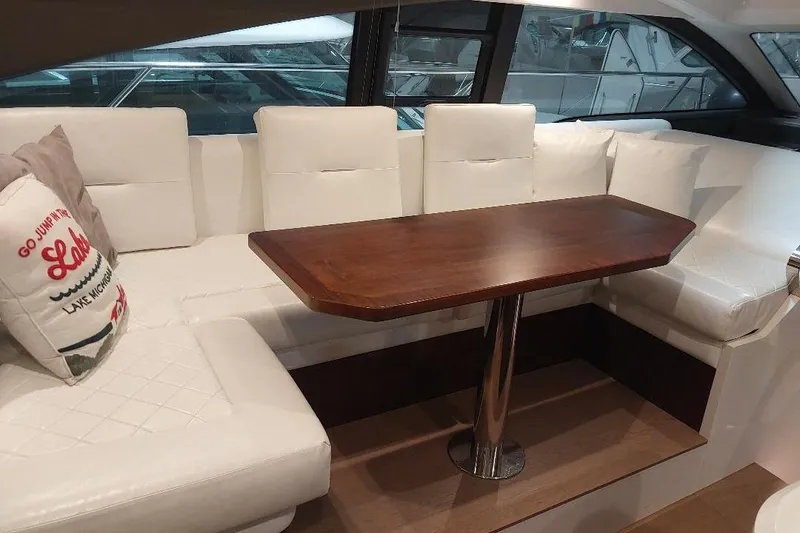 Slide: The Image of Luxurious interior of 2022 Fairline Targa 45 GT yacht with white seating and wooden table. - 10
