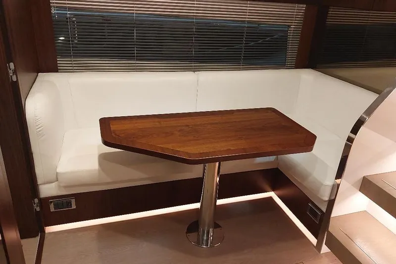 Slide: The Image of Luxurious interior of 2022 Fairline Targa 45 GT with elegant wood table and white seating. - 13