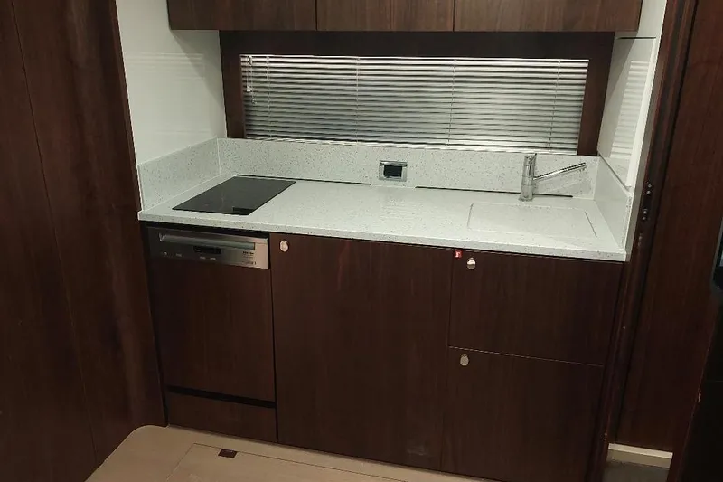 Slide: The Image of Modern kitchen in 2022 Fairline Targa 45 GT yacht with sleek dark wood cabinetry. - 14
