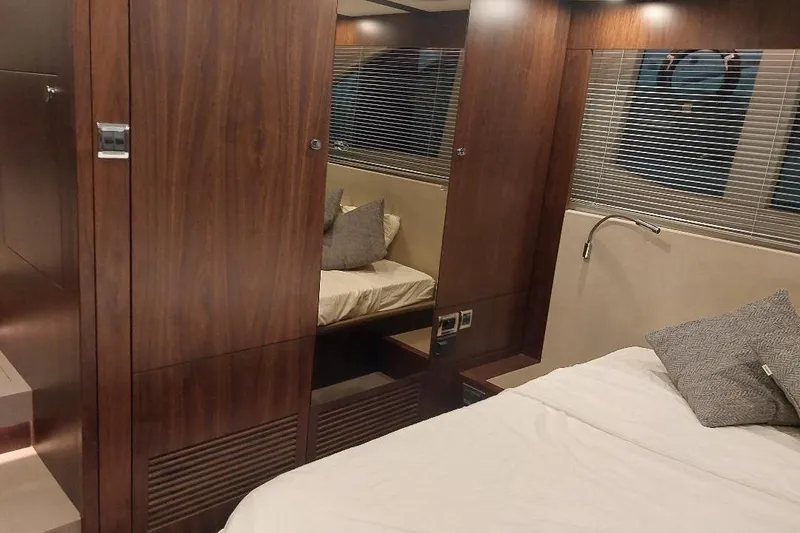 Slide: The Image of Luxurious interior of 2022 Fairline Targa 45 GT yacht with wood paneling and cozy bedding. - 18