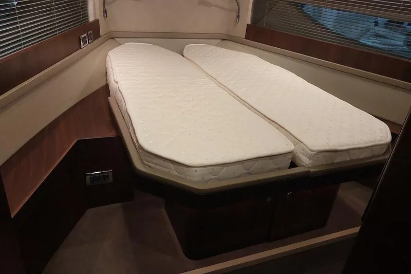 Slide: The Image of 2022 Fairline Targa 45 GT cabin with twin beds and modern interior design. - 19