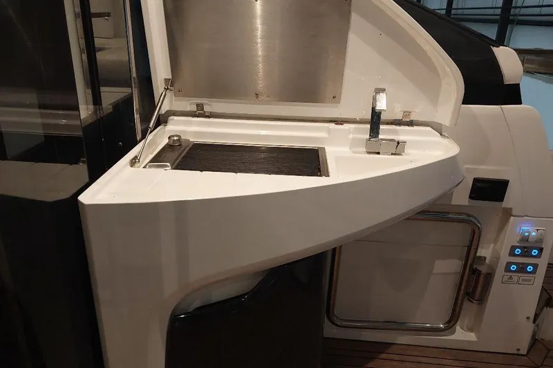 Slide: The Image of Outdoor kitchen area on 2022 Fairline Targa 45 GT yacht, featuring a grill and control panel. - 4