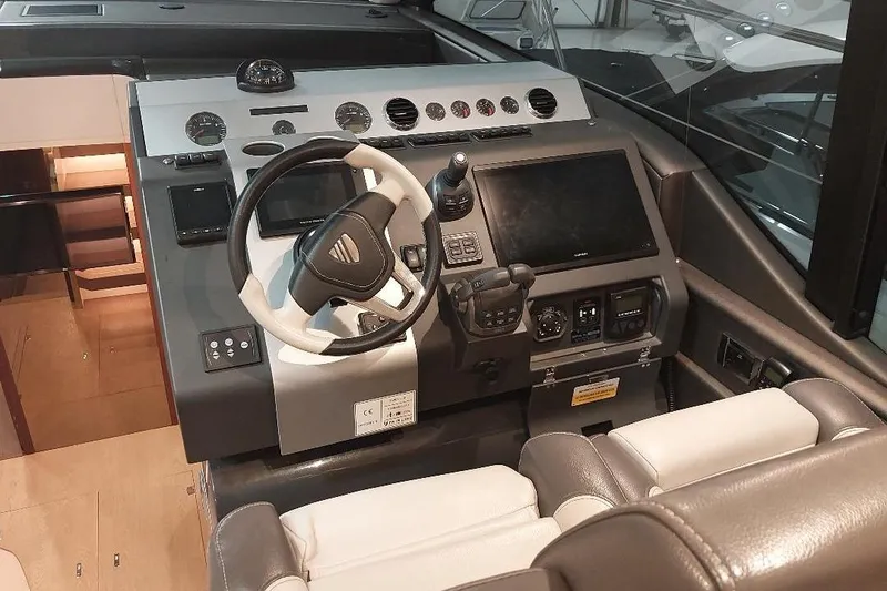 Slide: The Image of 2022 Fairline Targa 45 GT yacht helm with modern controls and navigation system. - 8