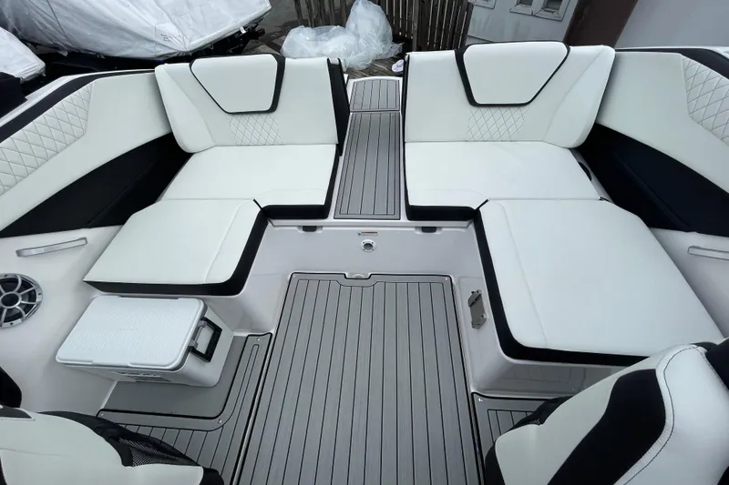 Slide: The Image of 2026 Yamaha Boats 222S interior with white cushioned seating and sleek flooring. - 15