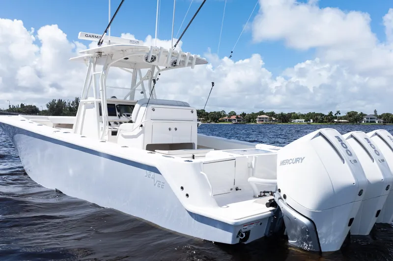 Slide: The Image of 2023 SeaVee 340Z boat on water, featuring sleek design and modern fishing equipment. - 1