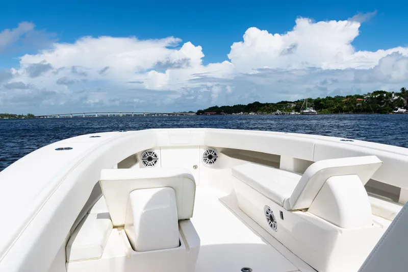 Slide: The Image of 2023 SeaVee 340Z boat interior with seating, on a sunny day, overlooking water and sky. - 11