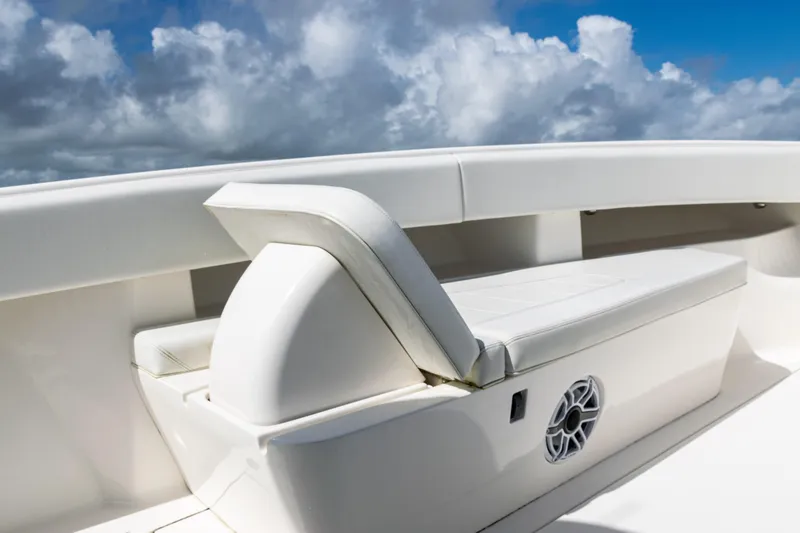 Slide: The Image of 2023 SeaVee 340Z boat seating with speaker, under a cloudy sky. - 13