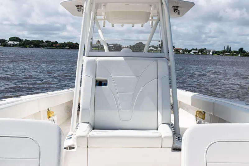 Slide: The Image of 2023 SeaVee 340Z boat interior with white seating, on a calm water backdrop. - 17