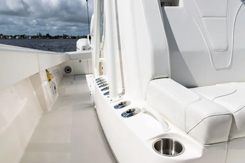 Slide: The Image of 2023 SeaVee 340Z boat interior with white seating and cup holders. - 21