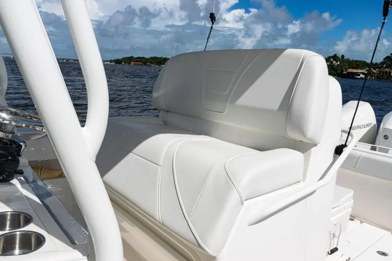 Slide: The Image of 2023 SeaVee 340Z boat with white seating, ocean view, and clear blue sky. - 23