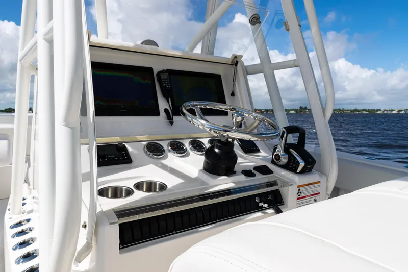 Slide: The Image of 2023 SeaVee 340Z boat dashboard with steering wheel and navigation screens. - 26