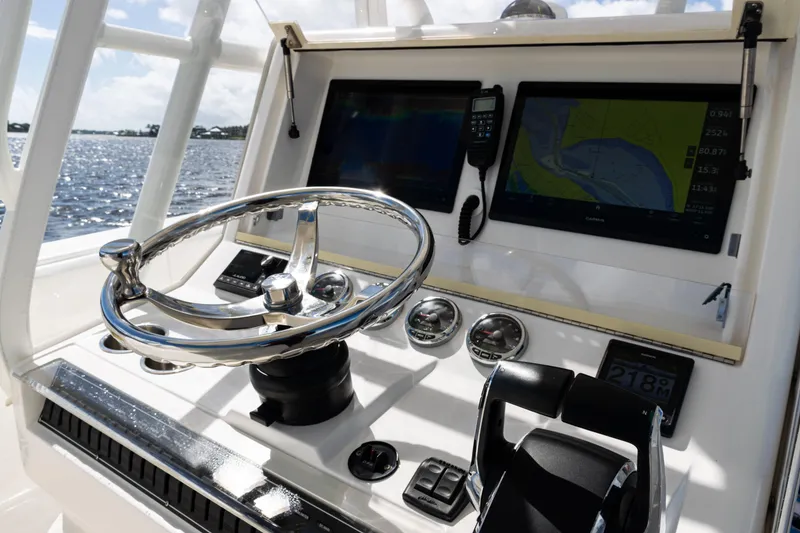 Slide: The Image of 2023 SeaVee 340Z boat dashboard with steering wheel and navigation screens. - 27