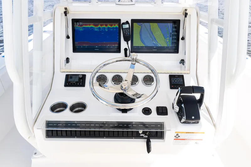 Slide: The Image of 2023 SeaVee 340Z boat dashboard with dual screens and steering wheel. - 29