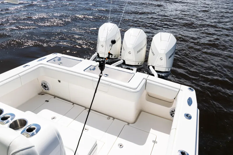 Slide: The Image of 2023 SeaVee 340Z boat with triple Mercury outboard engines on open water. - 31