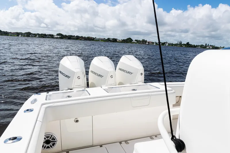 Slide: The Image of 2023 SeaVee 340Z boat with triple Mercury engines on a calm lake. - 32