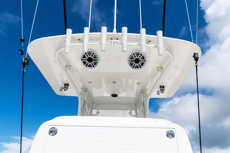 Slide: The Image of 2023 SeaVee 340Z boat top view with rod holders and speakers against blue sky. - 34