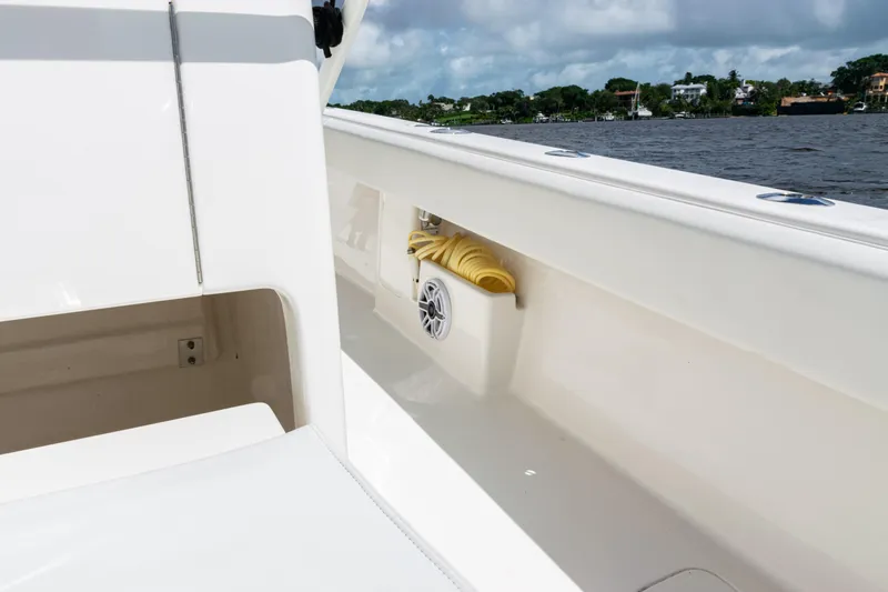 Slide: The Image of 2023 SeaVee 340Z boat interior with speaker and coiled rope, near water. - 35