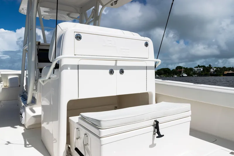 Slide: The Image of 2023 SeaVee 340Z boat interior with seating and storage, under a partly cloudy sky. - 41