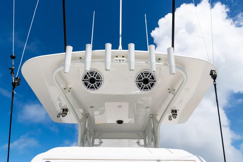 Slide: The Image of 2023 SeaVee 340Z boat top view with rod holders and speakers against blue sky. - 43