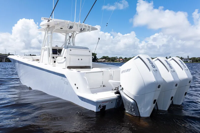 Slide: The Image of 2023 SeaVee 340Z boat with triple Mercury engines on a sunny day. - 46