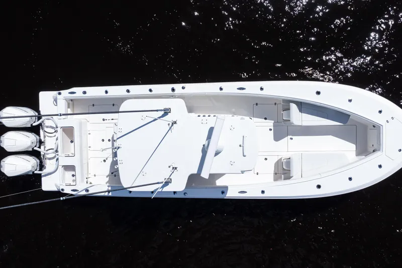 Slide: The Image of Aerial view of 2023 SeaVee 340Z boat with triple outboard engines on dark water. - 49