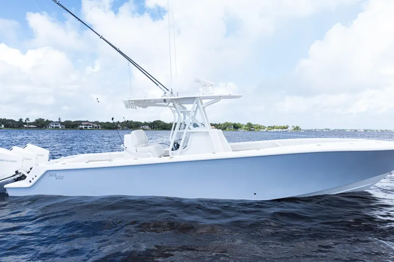 Slide: The Image of 2023 SeaVee 340Z boat on calm water under a partly cloudy sky. - 52