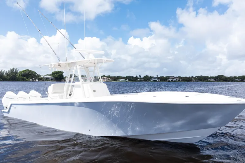 Slide: The Image of 2023 SeaVee 340Z boat on calm water under a partly cloudy sky. - 53