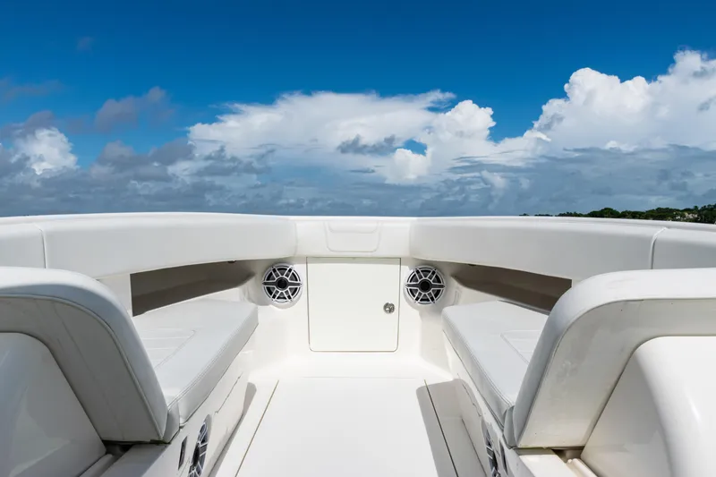 Slide: The Image of 2023 SeaVee 340Z boat interior with white seating and blue sky background. - 6