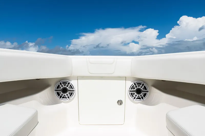 Slide: The Image of 2023 SeaVee 340Z boat interior with speakers, under a clear blue sky. - 9