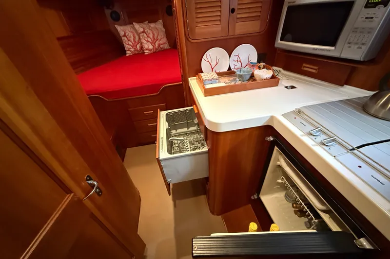 Slide: The Image of Hinckley Talaria 40 yacht interior, featuring a cozy cabin and modern kitchen amenities. - 15