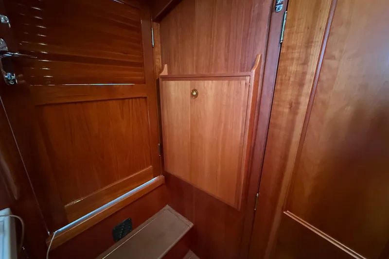 Slide: The Image of Interior wooden cabinetry of a 2003 Hinckley Talaria 40 yacht, showcasing elegant craftsmanship. - 17