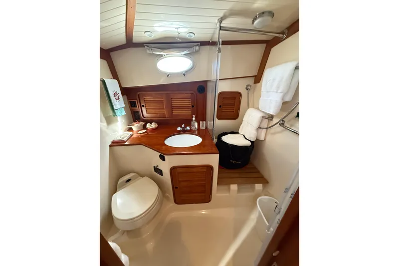 Slide: The Image of Luxurious 2003 Hinckley Talaria 40 yacht bathroom with wooden accents and modern amenities. - 19