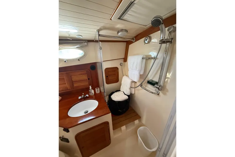 Slide: The Image of Luxurious bathroom interior of 2003 Hinckley Talaria 40 yacht with wooden accents. - 20