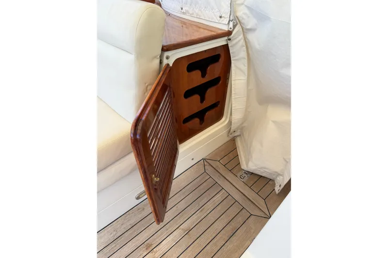 Slide: The Image of Hinckley Talaria 40 interior detail, featuring wooden storage compartment and cushioned seating, 2003 model. - 3