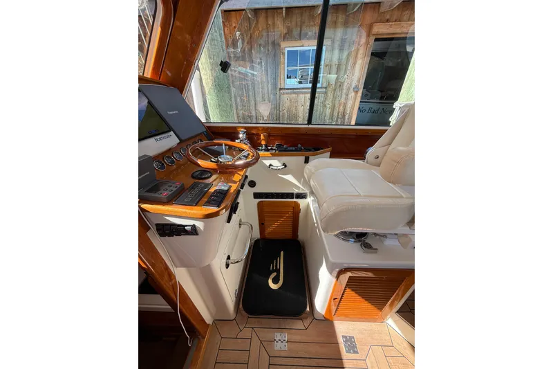 Slide: The Image of 2003 Hinckley Talaria 40 helm with wooden dashboard and leather seating. - 6