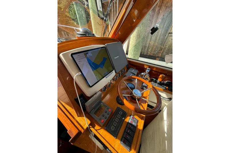 Slide: The Image of Helm of 2003 Hinckley Talaria 40 with navigation system and wooden steering wheel. - 7