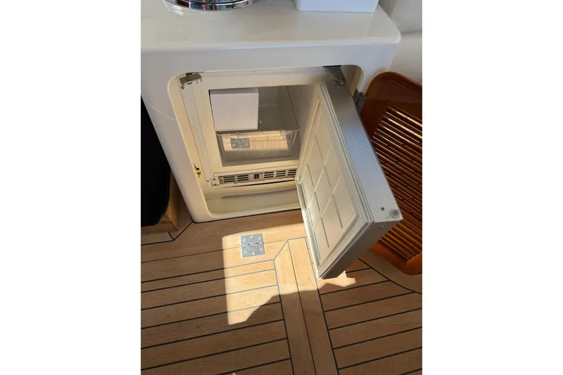 Slide: The Image of Open refrigerator on 2003 Hinckley Talaria 40 yacht with wooden flooring. - 9