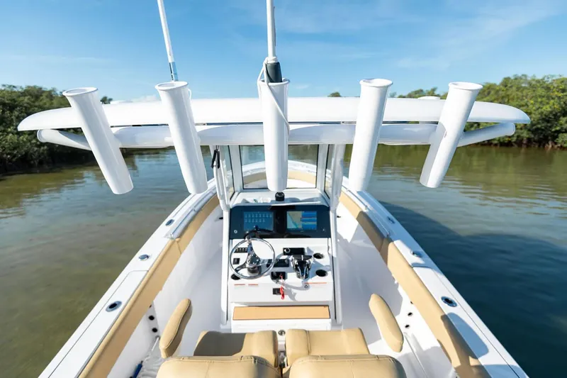 Slide: The Image of Manufacturer Provided Image: 2025 Sportsman Open 252 Center Console boat on calm water, featuring modern helm and seating. - 6